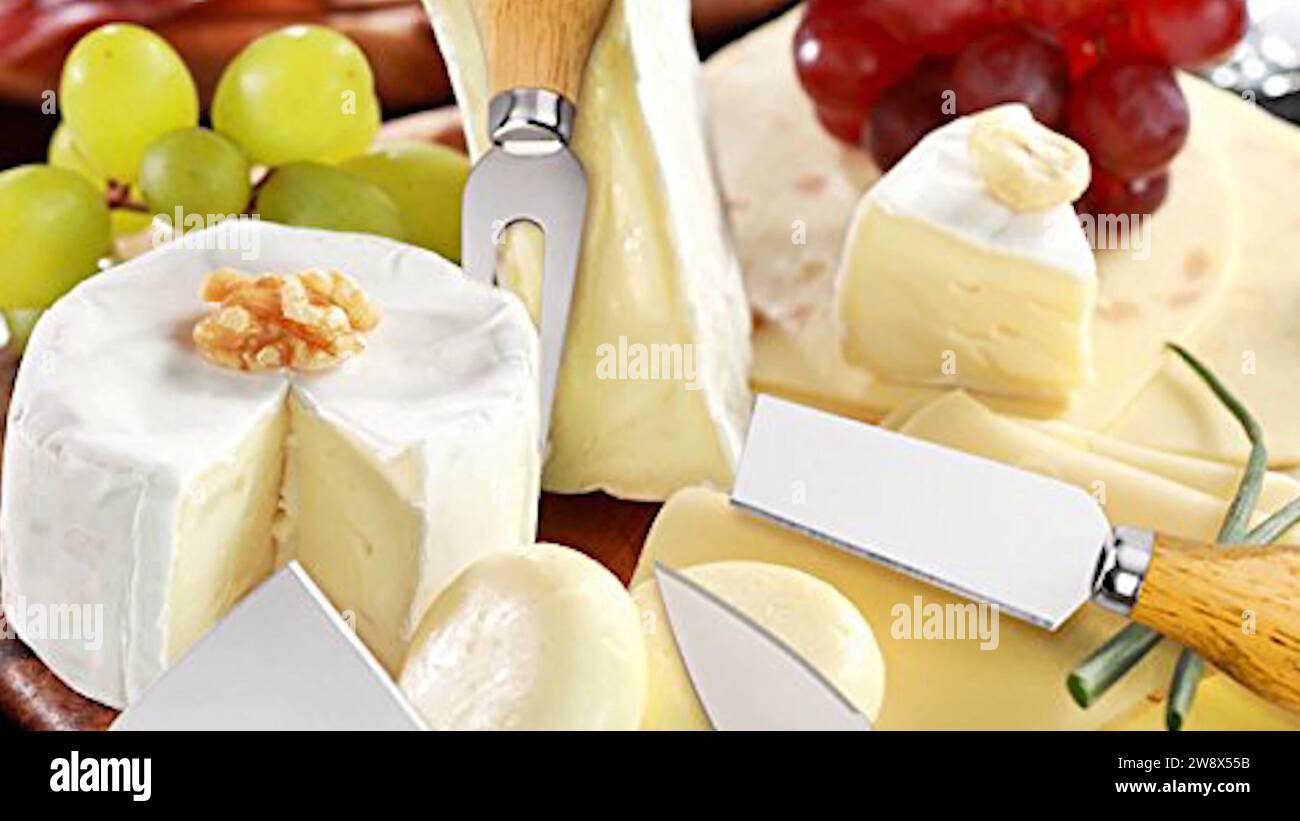 Italian Cheese Food Platter - Skillfully arranged sliced cheese blocks - Gourmet Italian cheese on the tabletop, variety of cheeses beautifully paired Stock Photo