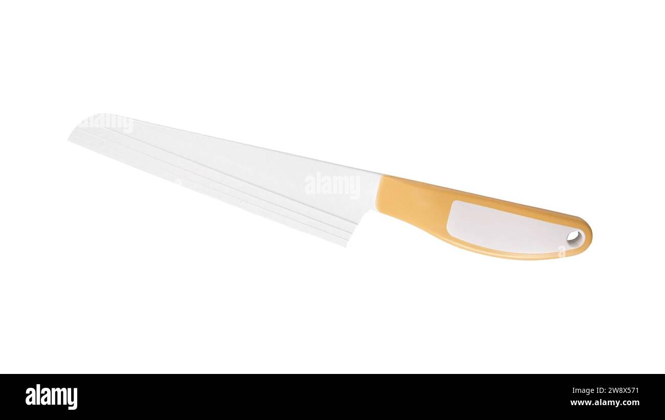 Cutting soft cheese with a specialized stainless steel Cheese Knife. Its blade, adorned with holes, creates perfect cheese slices. Kitchen essential Stock Photo