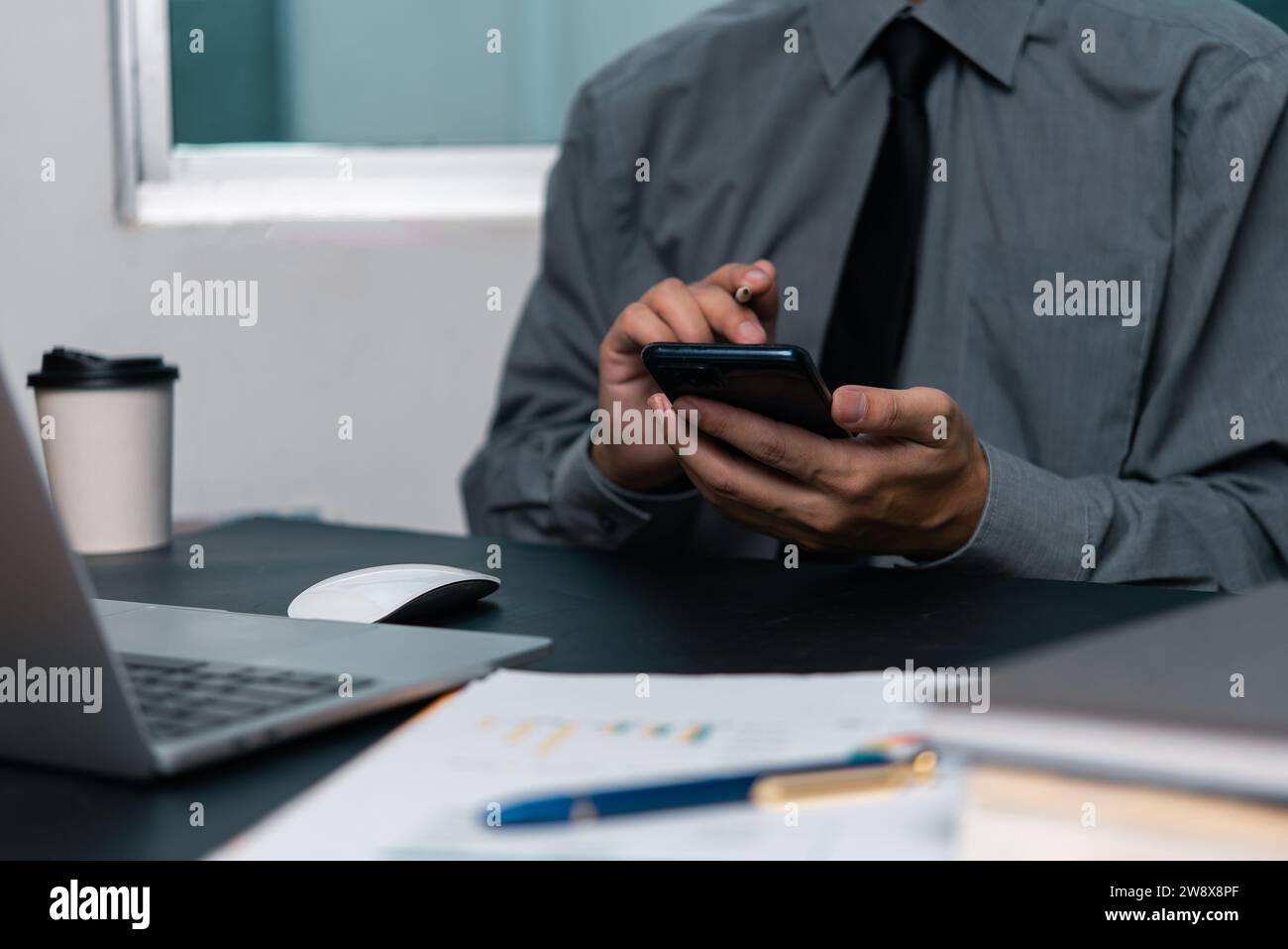 man using  mobile smartphone working and digital online computer laptop at office Stock Photo
