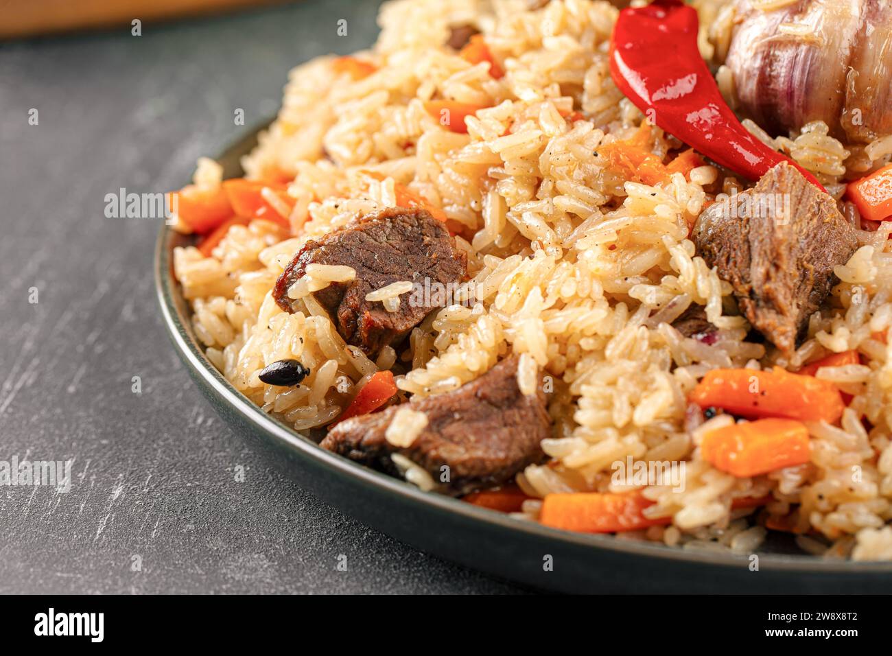 Large dish with Uzbek festive pilaf plov Stock Photo
