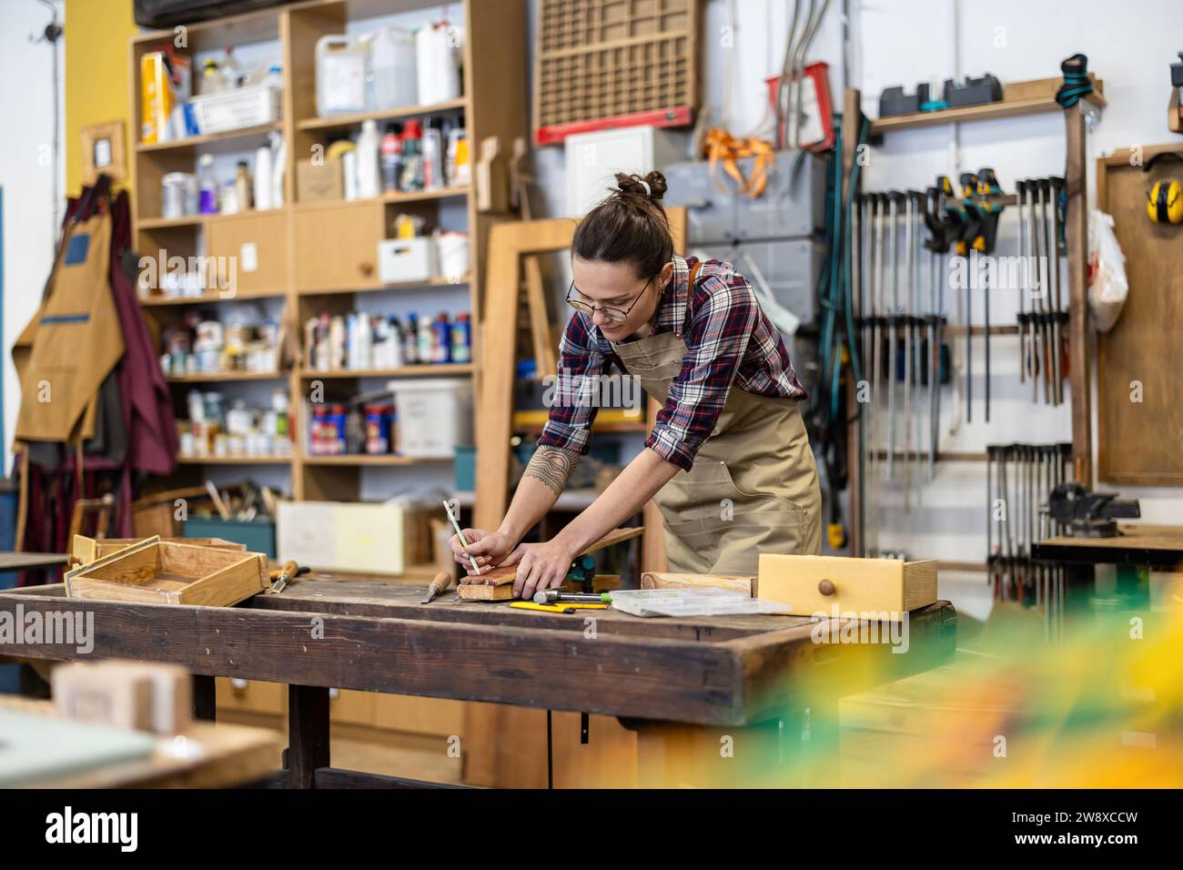 Female carpenter working in her workshop Stock Photo