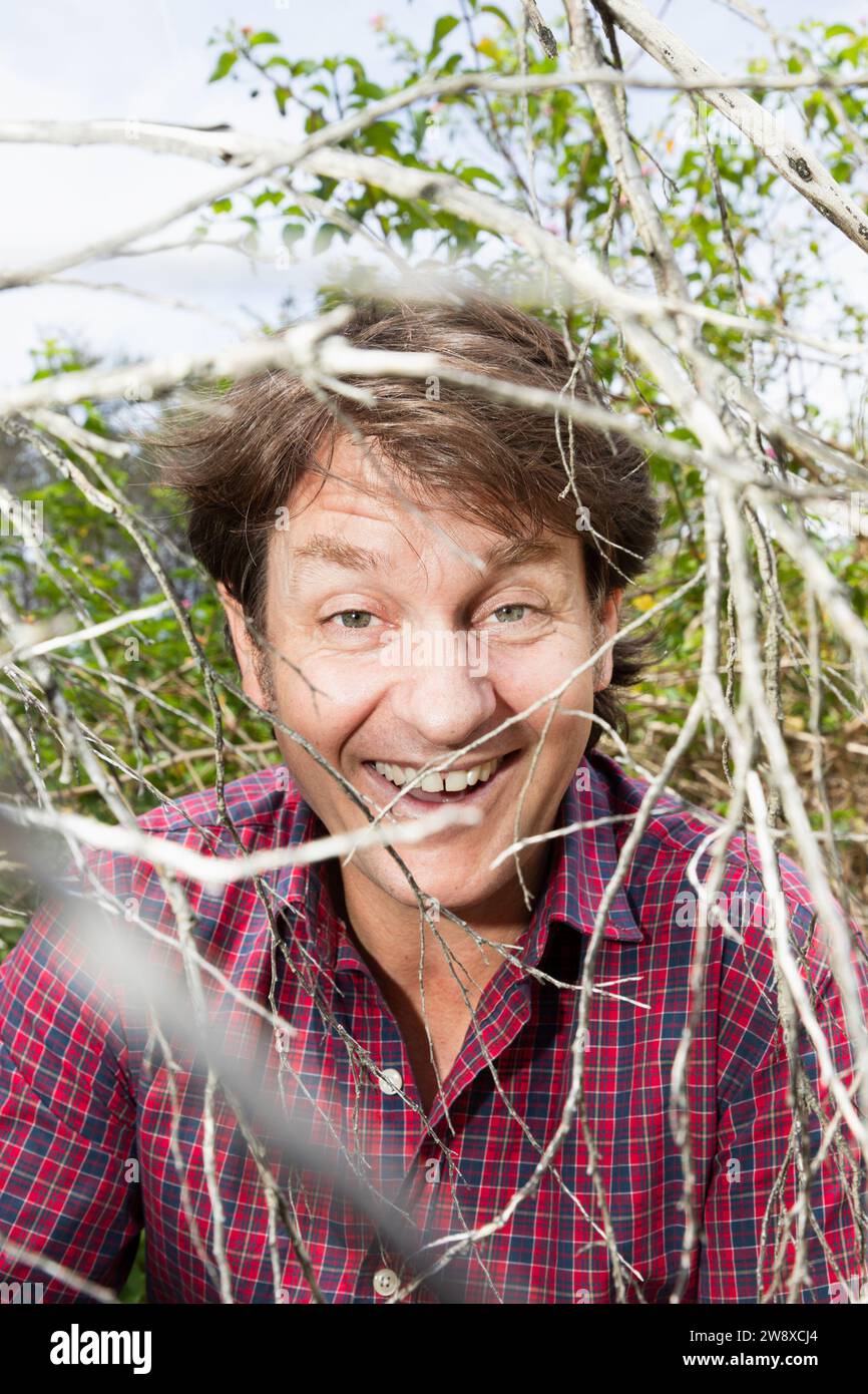 Craig Reucassel, Australian television and radio comedian, known for satirical team The Chaser, and The War on Waste. Editorial portrait in scrubland. Stock Photo