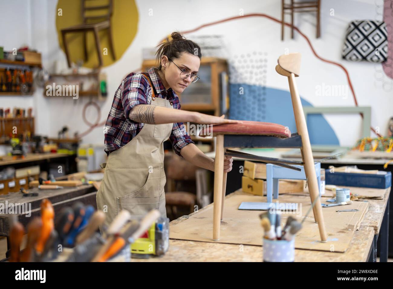 Female carpenter working in her workshop Stock Photo