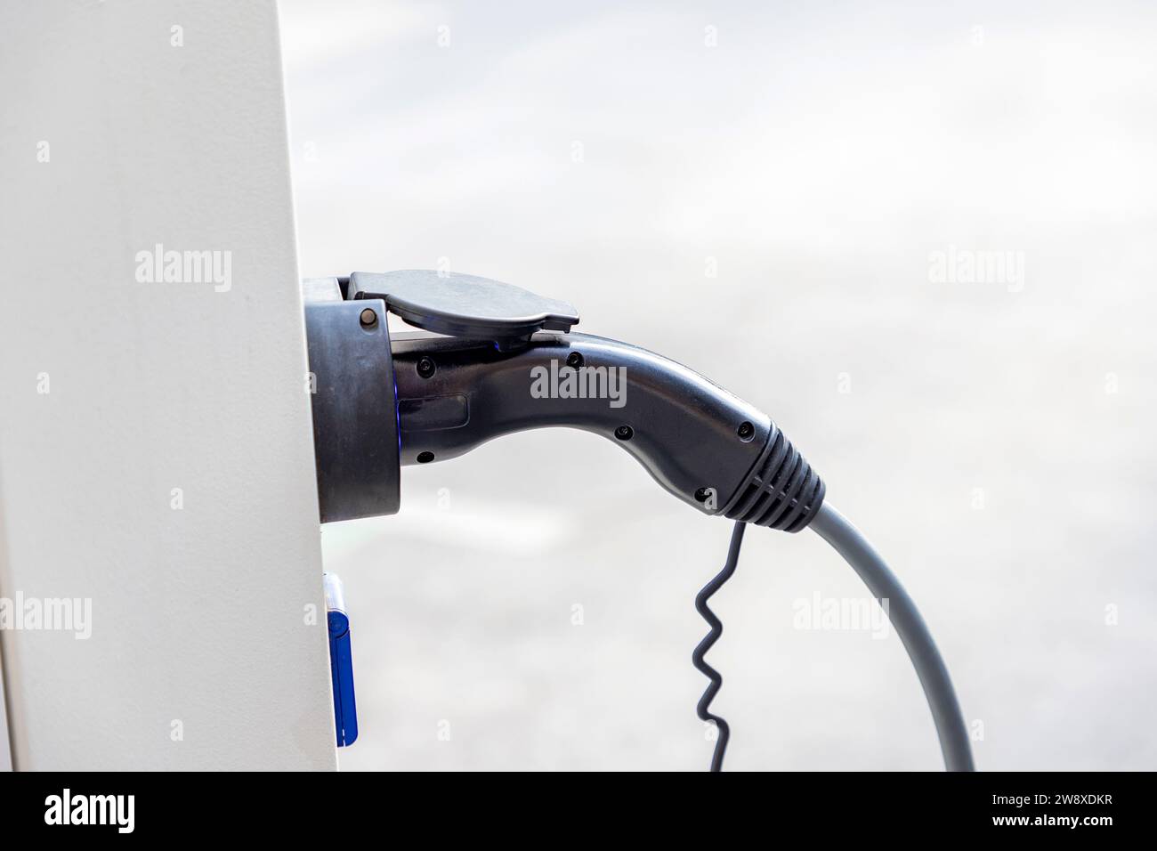 Closeup of charger plug to an electric vehicle from charging station. Stock Photo