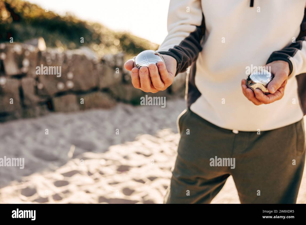 Midsection of senior man holding Petanque balls in hand Stock Photo