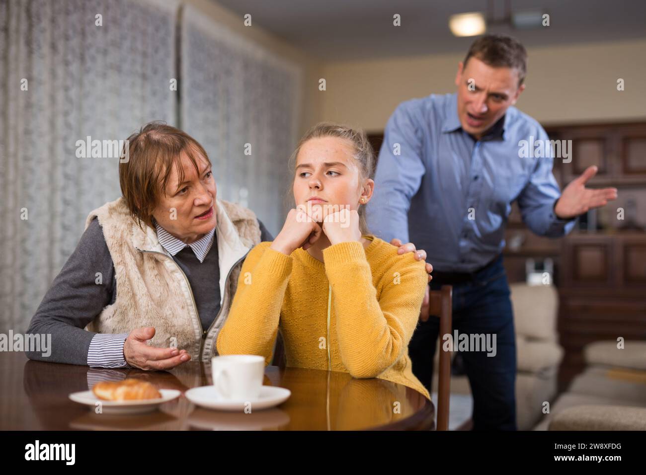 Repromanding Teenage girl listening reprimanding from father and grandmother Stock ...
