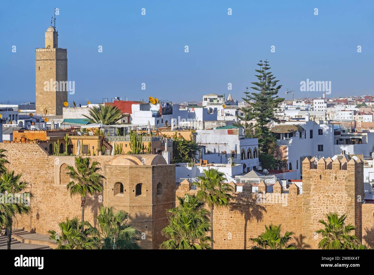 City walls of the Kasbah of the Udayas / Oudaias and Minaret of the Old Mosque in the capital Rabat at sunset, Rabat-Salé-Kénitra, Morocco Stock Photo