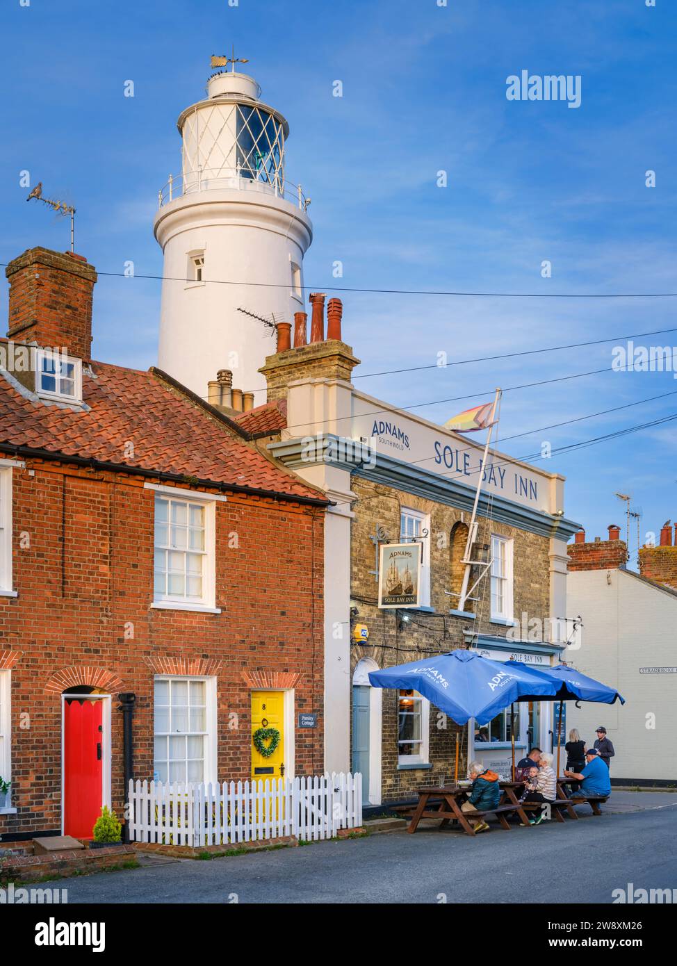 People enjoy a summers evening drink at The Sole Bay Inn in Southwold, Suffolk, England. Stock Photo