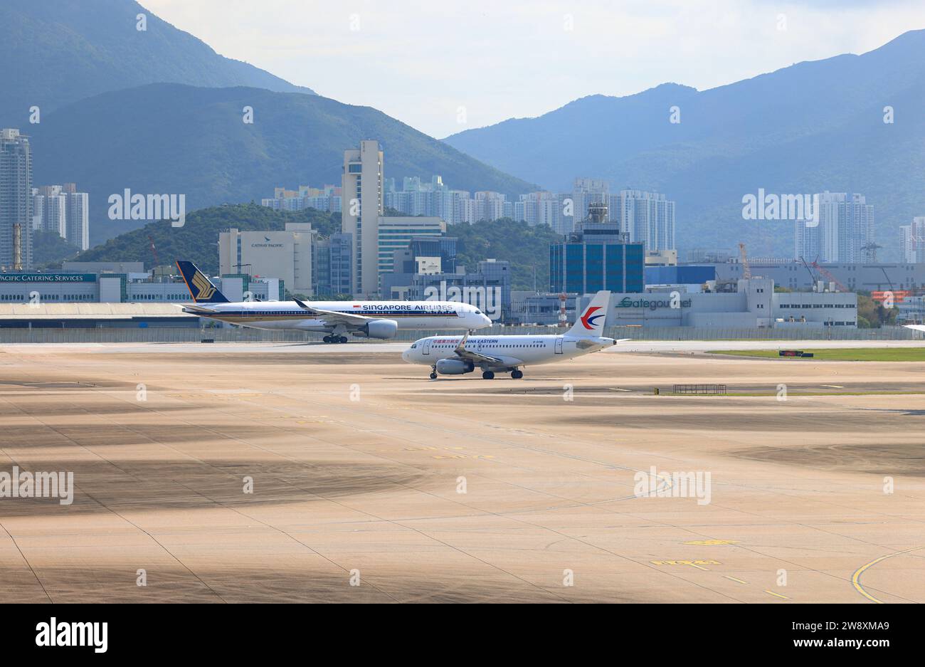 Singapore Airlines fleet Airbus A350-900 and China Eastern Airlines fleet Airbus A319 operated at Hong Kong International Airport. Stock Photo
