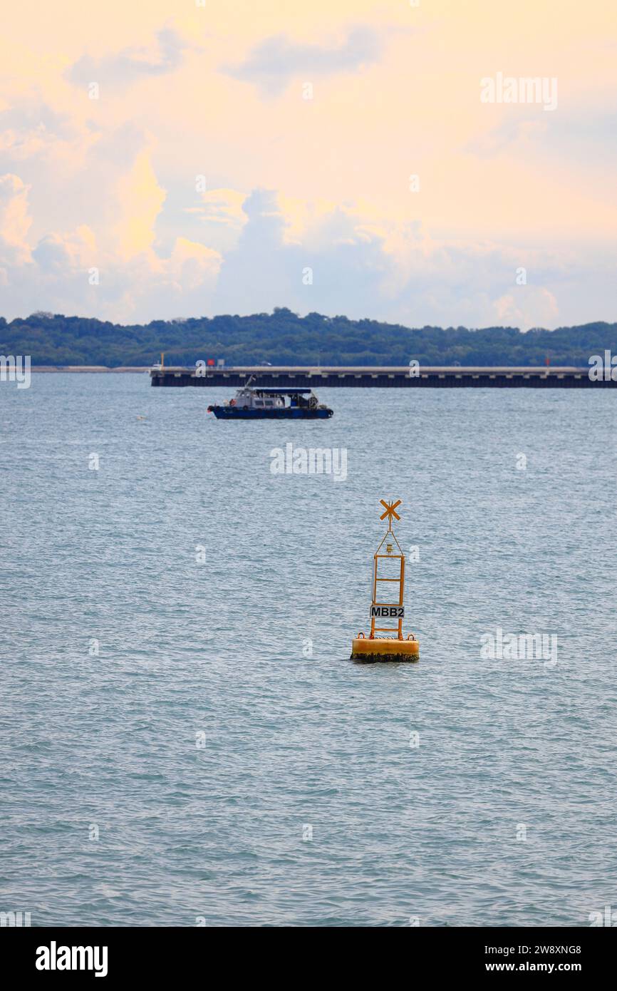 Marine buoy floating in the blue sea, Red coastal buoy in the sea for