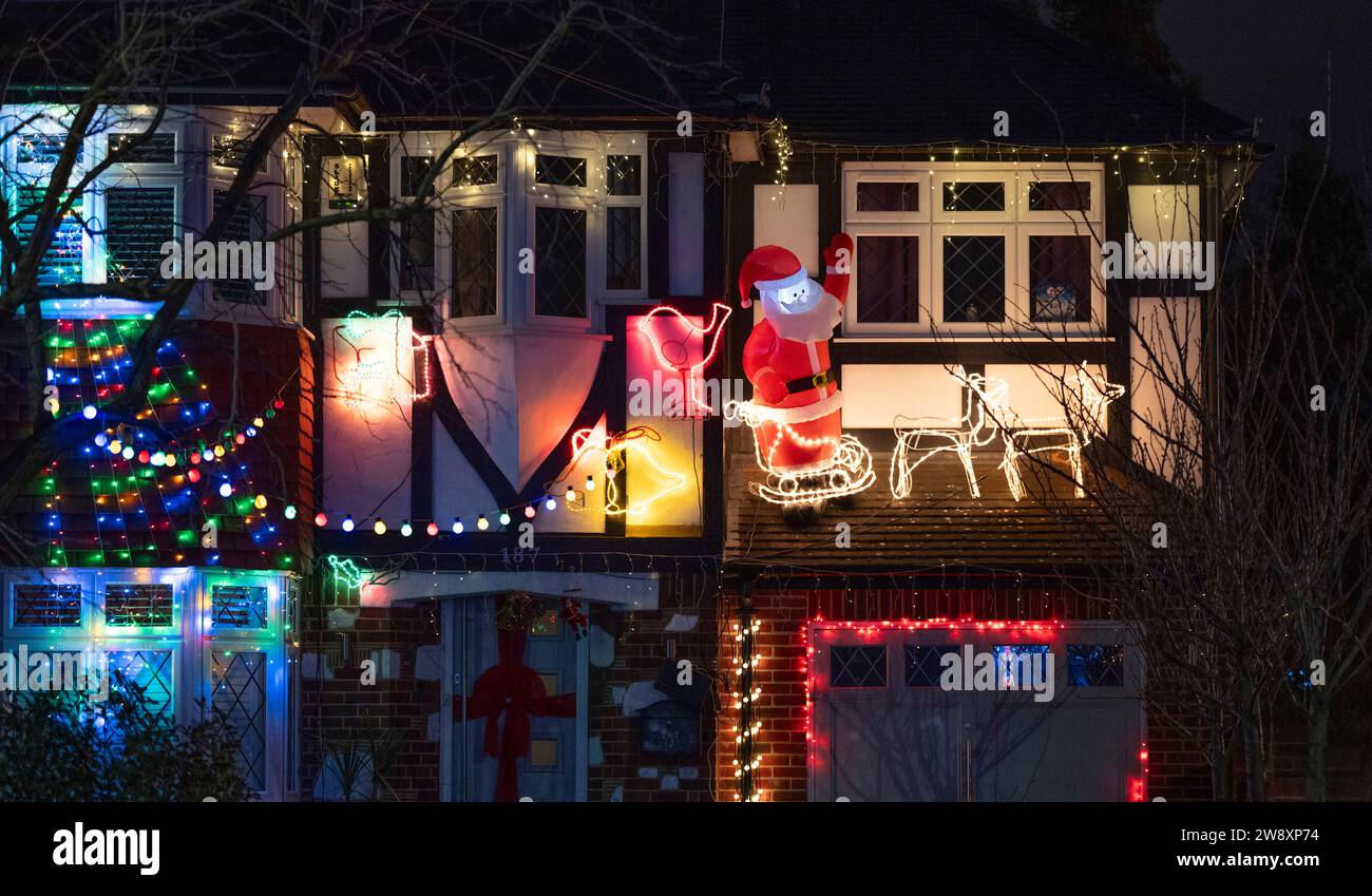 Lower Morden, Surrey, London, UK. 22nd Dec, 2023. Many residents of Lower Morden Lane decorate the exterior of their homes each Christmas. Visitors to the street donate to the collecting boxes locally and the money is given to a good local cause - St Raphael’s Hospice. Credit: Malcolm Park/Alamy Live News Stock Photo