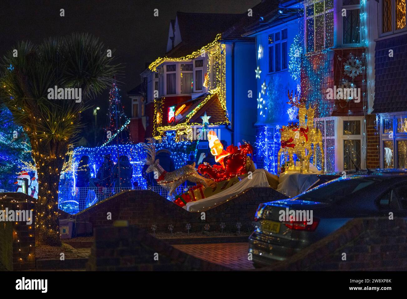 Lower Morden, Surrey, London, UK. 22nd Dec, 2023. Many residents of Lower Morden Lane decorate the exterior of their homes each Christmas. Visitors to the street donate to the collecting boxes locally and the money is given to a good local cause - St Raphael’s Hospice. Credit: Malcolm Park/Alamy Live News Stock Photo
