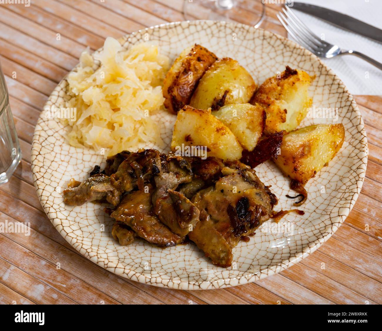 Rabbit liver with boiled potatoes and sauerkraut Stock Photo - Alamy