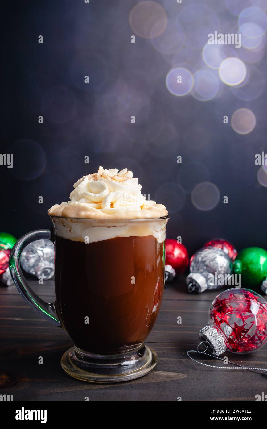 Spiced Christmas Coffee Topped with Whipped Cream: Large glass mug of freshly brewed spiced coffee surrounded with Christmas ornaments Stock Photo
