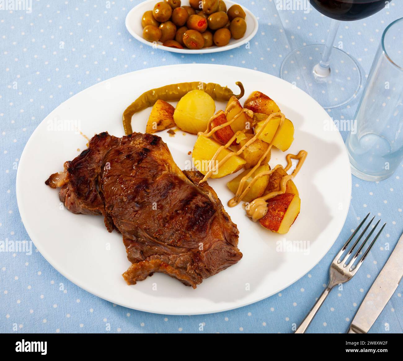 Beef sirloin steak with baked green pepper and potatoes Stock Photo - Alamy