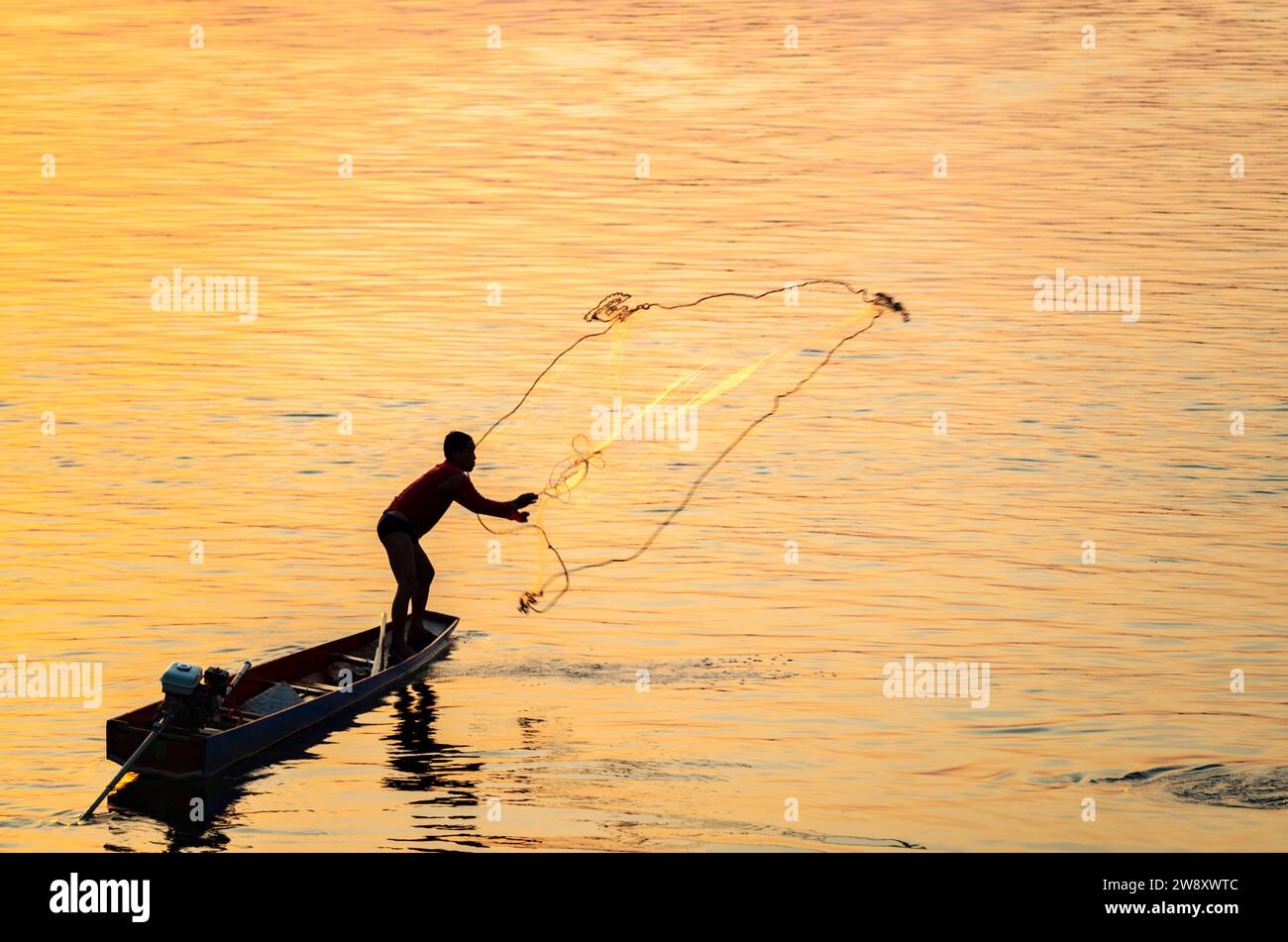 Silhouette of a man throwing fishing net hi-res stock photography and  images - Alamy