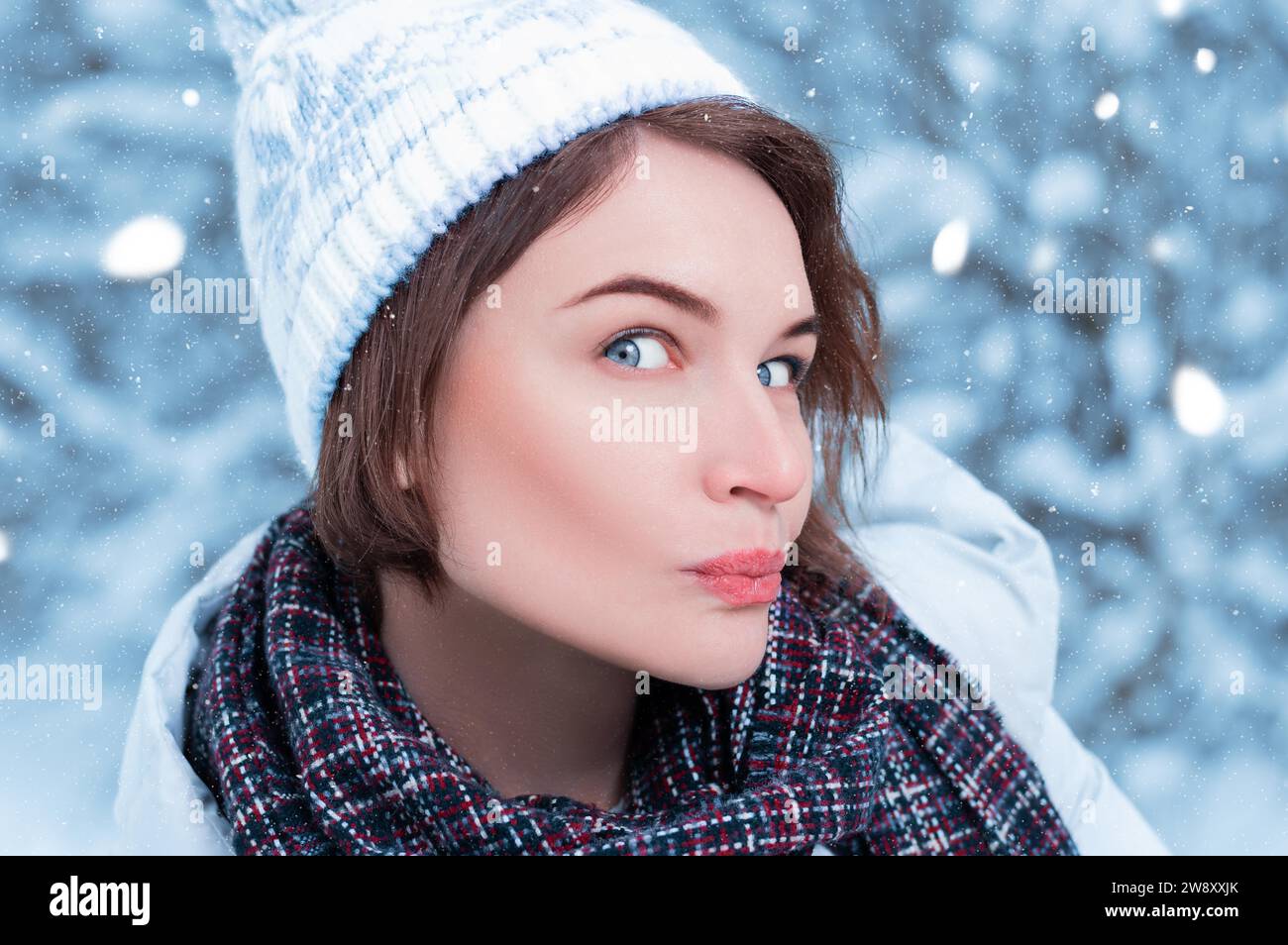 Beautiful model makes a funny surprised face. Winter forest. Warm