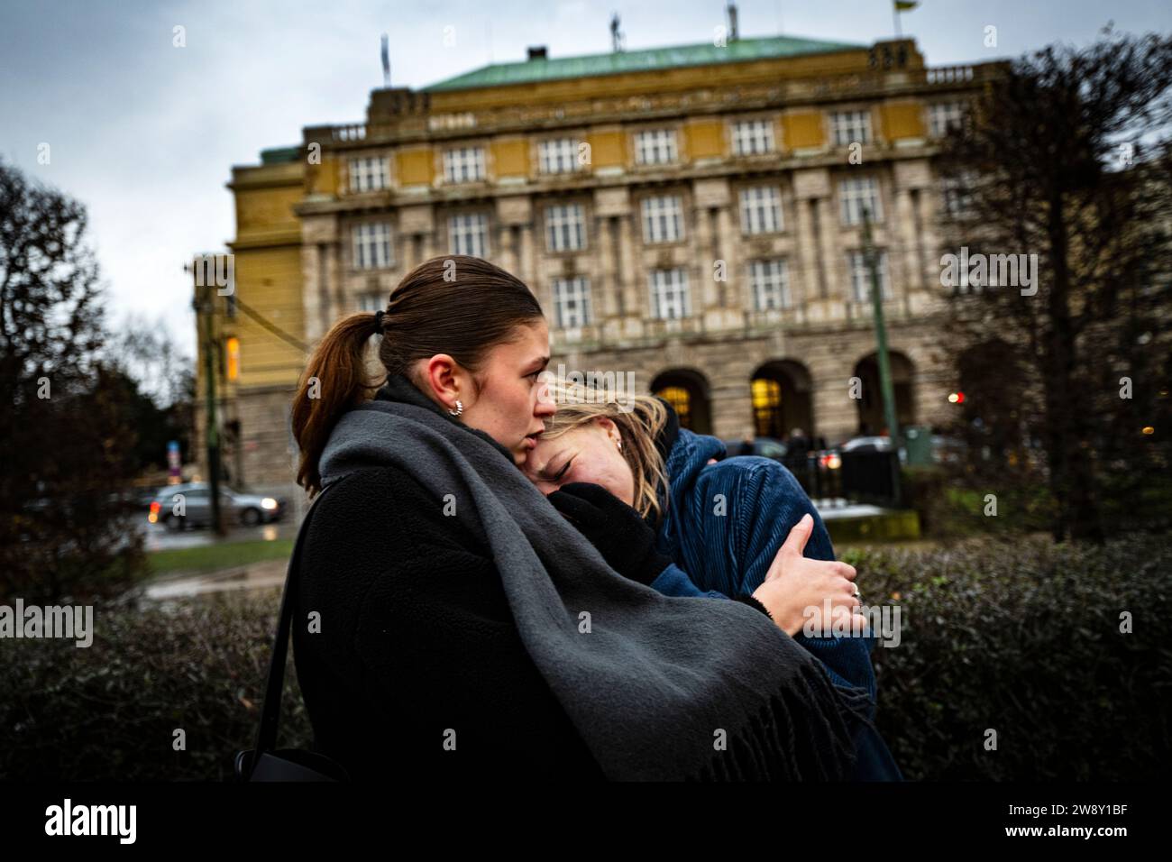 Prague, Czech Republic. 22nd Dec, 2023. Women hug at a memorial site on Jan Palach Square for the victims of the shooting from the previous day at the Faculty of Arts, Charles University, in Prague, Czech Republic, on December 22, 2023. Twenty-four-year-old student shot dead 14 people and wounded 25 others at the school. Credit: Roman Vondrous/CTK Photo/Alamy Live News Stock Photo