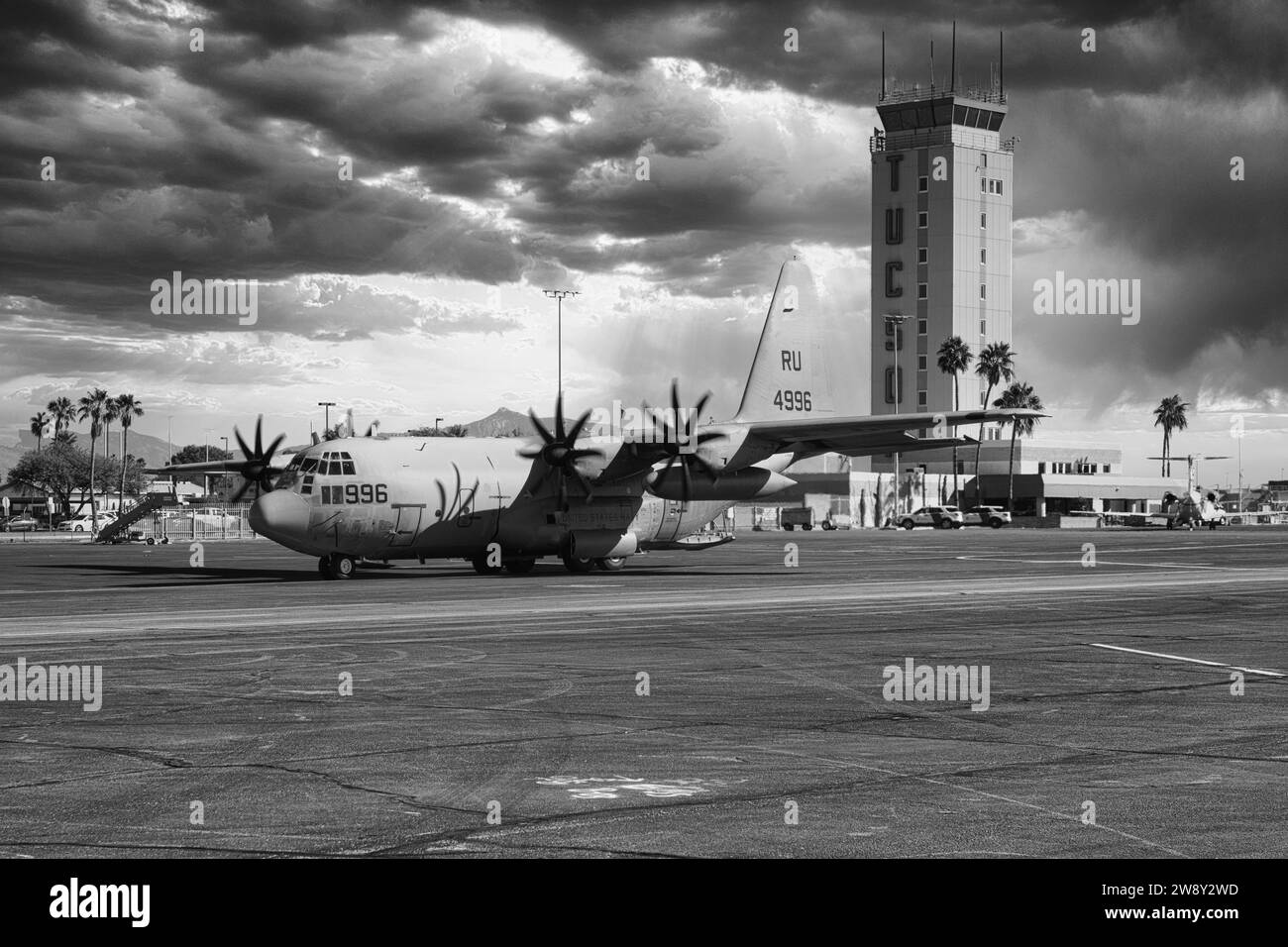 C130 of the US Navy taxiies past the Control Tower at Tucson International Airport in Arizona Stock Photo