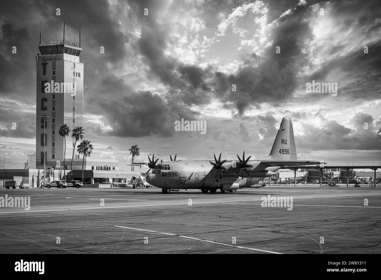 C130 of the US Navy taxiies past the Control Tower at Tucson International Airport in Arizona Stock Photo