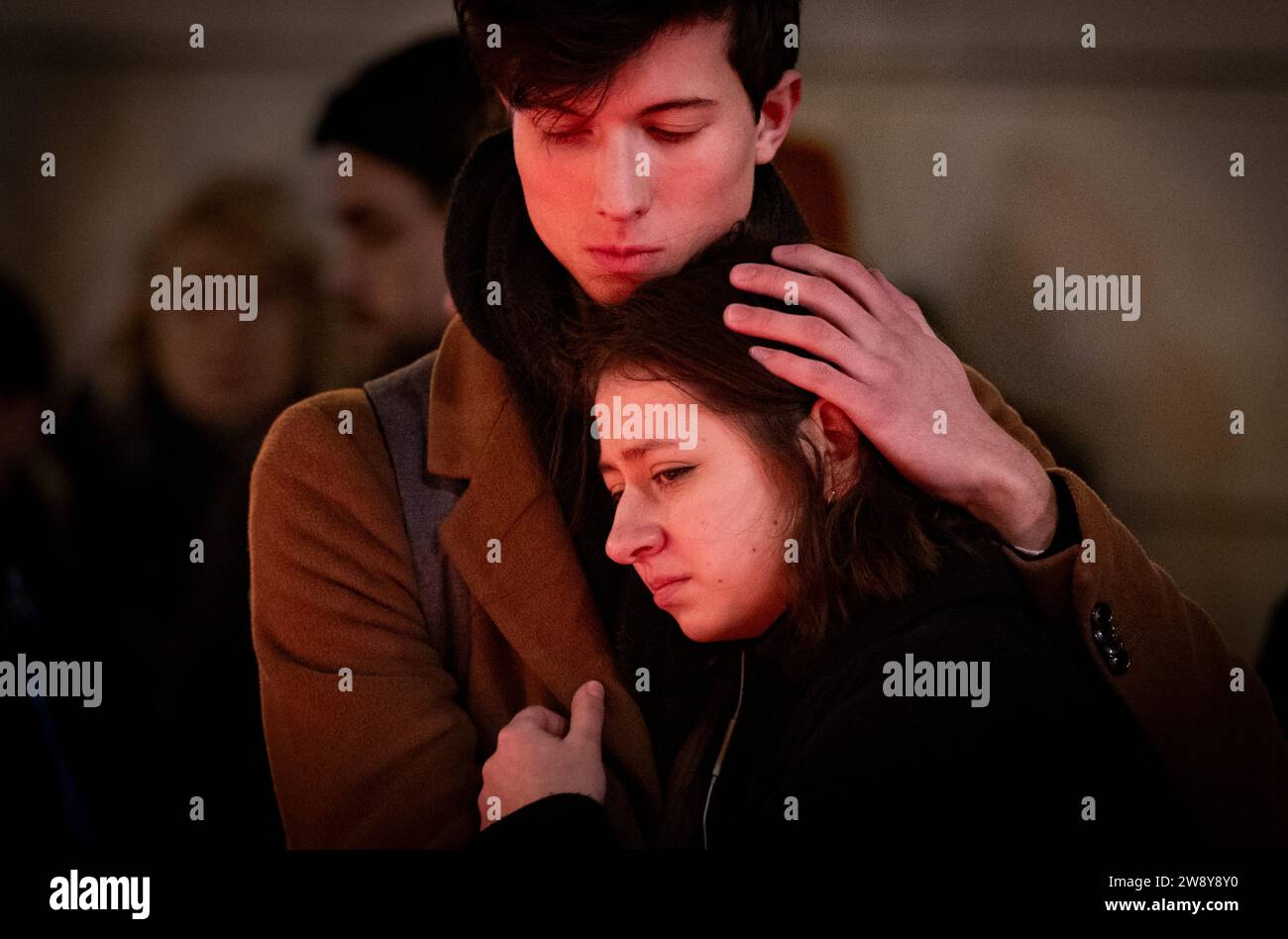Prague, Czech Republic. 22nd Dec, 2023. A pair hug at memorial place created in front of the Karolinum for the victims of the shooting from the previous day at the Faculty of Arts, Charles University, in Prague, Czech Republic, on December 22, 2023. Twenty-four-year-old student shot dead 14 people and wounded 25 others at the school. Credit: Roman Vondrous/CTK Photo/Alamy Live News Stock Photo