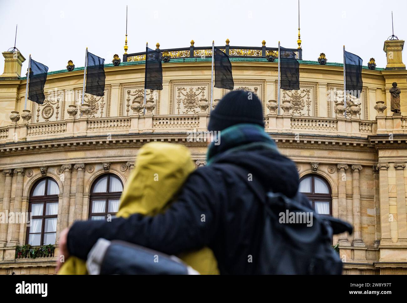 Prague, Czech Republic. 22nd Dec, 2023. A pair hug in front of Rudolfinum Hall at a memorial site on Jan Palach Square for the victims of the shooting from the previous day at the Faculty of Arts, Charles University, in Prague, Czech Republic, on December 22, 2023. Twenty-four-year-old student shot dead 14 people and wounded 25 others at the school. Credit: Roman Vondrous/CTK Photo/Alamy Live News Stock Photo