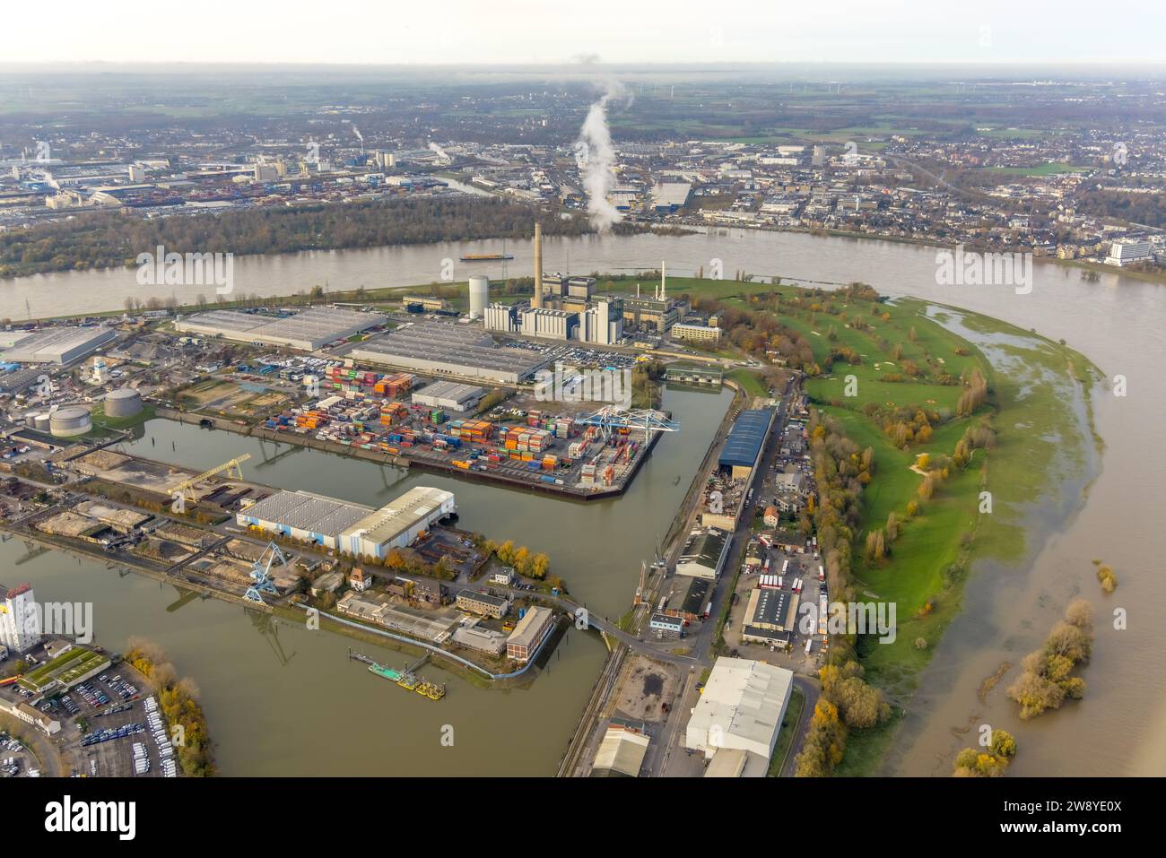 Aerial view, Lausward power plant and smoke cloud at the Medienhafen, flood at the river Rhine, distant view and sky, surrounded by autumnal deciduous Stock Photo