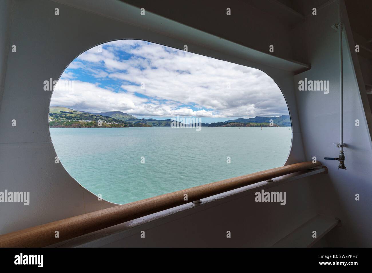 The view of Diamond Harbor (left) Quail Island (right) and Charteris Bay from the promenade deck of the Holland America Line  MS Noordam Lyttleton, NZ Stock Photo