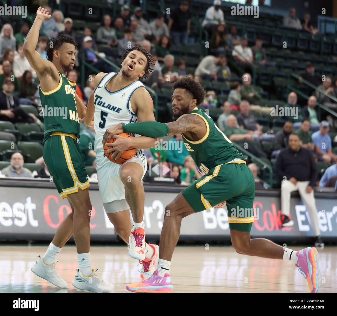 New Orleans, USA. 22nd Dec, 2023. George Mason Patriots guard Jared Billups (0) tries to strip the ball from Tulane Green Wave forward Collin Holloway (5) during a men's basketball game at Fogleman Arena in New Orleans, Louisiana on Friday, December 22, 2023. (Photo by Peter G. Forest/Sipa USA) Credit: Sipa USA/Alamy Live News Stock Photo
