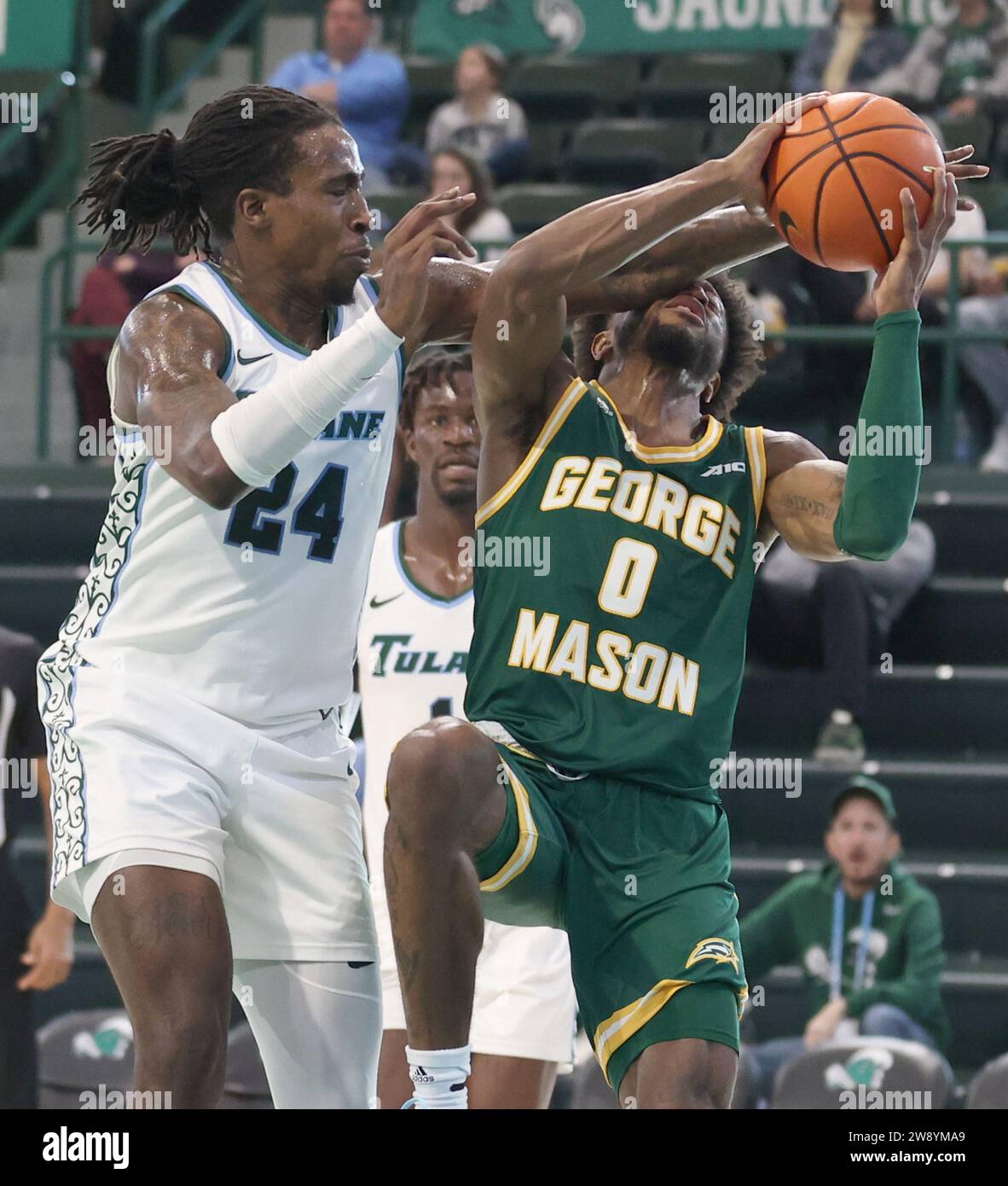 New Orleans, USA. 22nd Dec, 2023. Tulane Green Wave forward Kevin Cross (24) commits a hard foul against George Mason Patriots guard Jared Billups (0) during a men's basketball game at Fogleman Arena in New Orleans, Louisiana on Friday, December 22, 2023. (Photo by Peter G. Forest/Sipa USA) Credit: Sipa USA/Alamy Live News Stock Photo