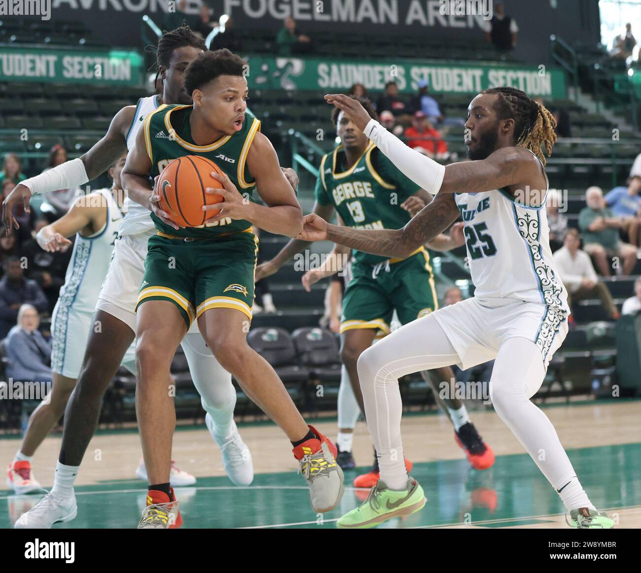 New Orleans, USA. 22nd Dec, 2023. George Mason Patriots guard Keyshawn Hall (4) tries to make a move against Tulane Green Wave guard Jaylen Forbes (25) and Tulane Green Wave forward Kevin Cross (24) during a men's basketball game at Fogleman Arena in New Orleans, Louisiana on Friday, December 22, 2023. (Photo by Peter G. Forest/Sipa USA) Credit: Sipa USA/Alamy Live News Stock Photo