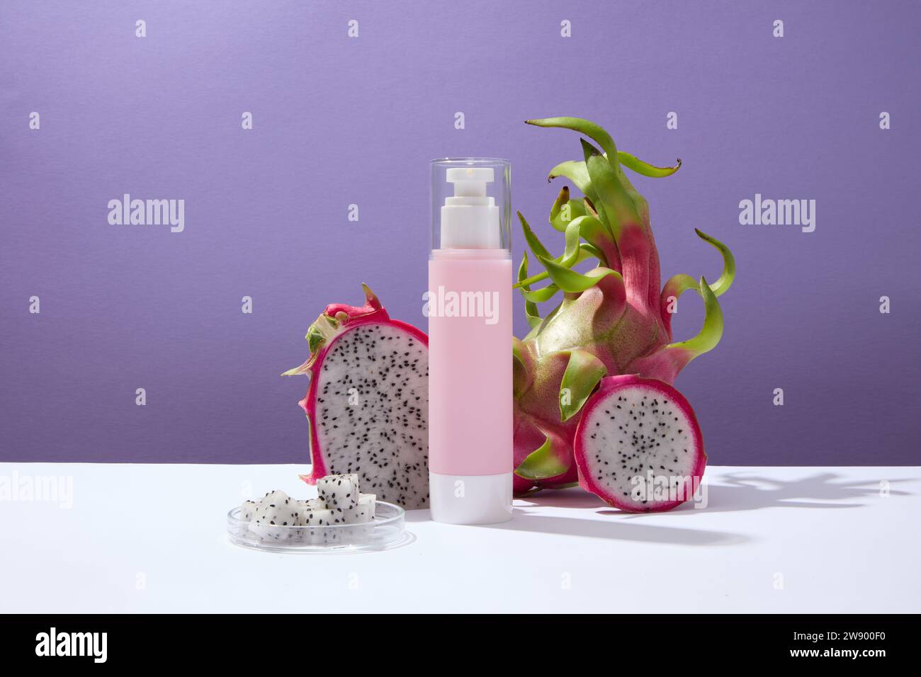 Fresh dragon fruit and dragon fruit slices decorated with a pink pump