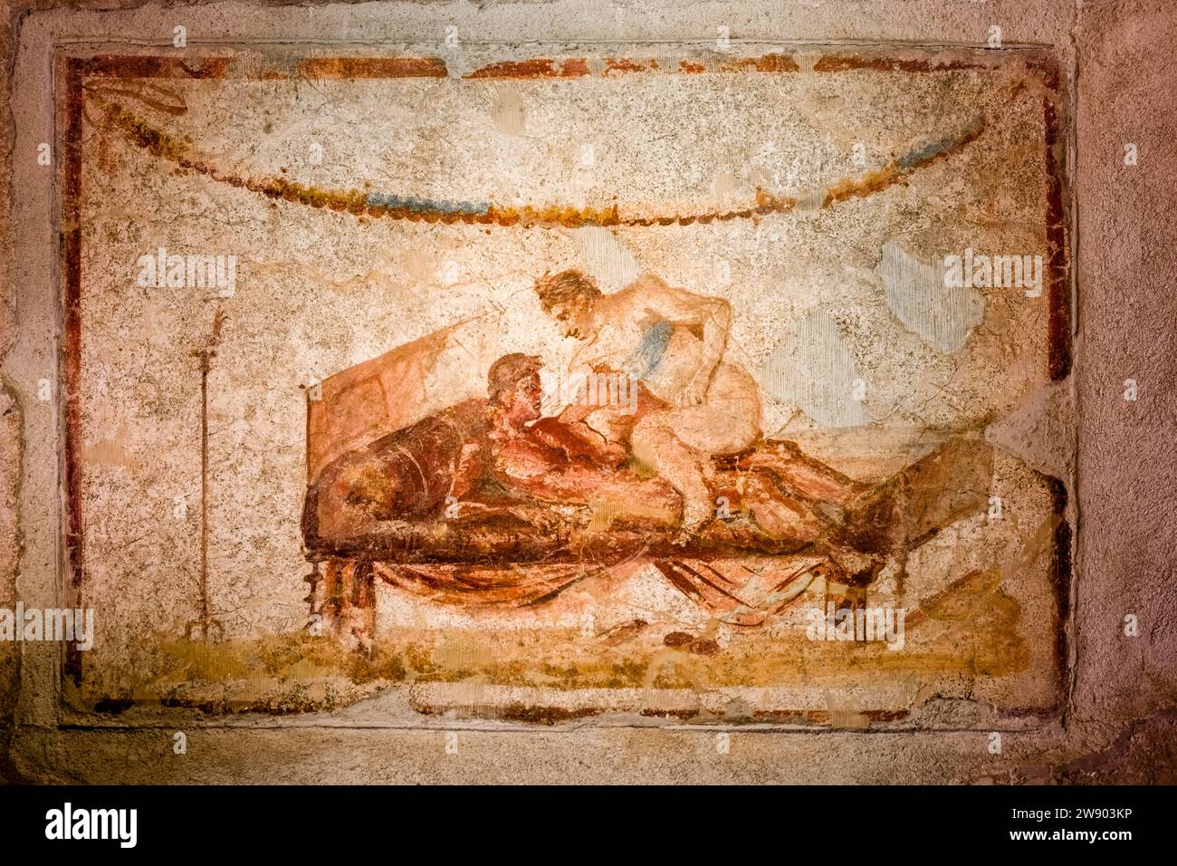 Wall paintings in the Lupanar, brothel in the archaeological site of Pompeii, an ancient city destroyed by the eruption of Mount Vesuvius in 79 AD. Stock Photo