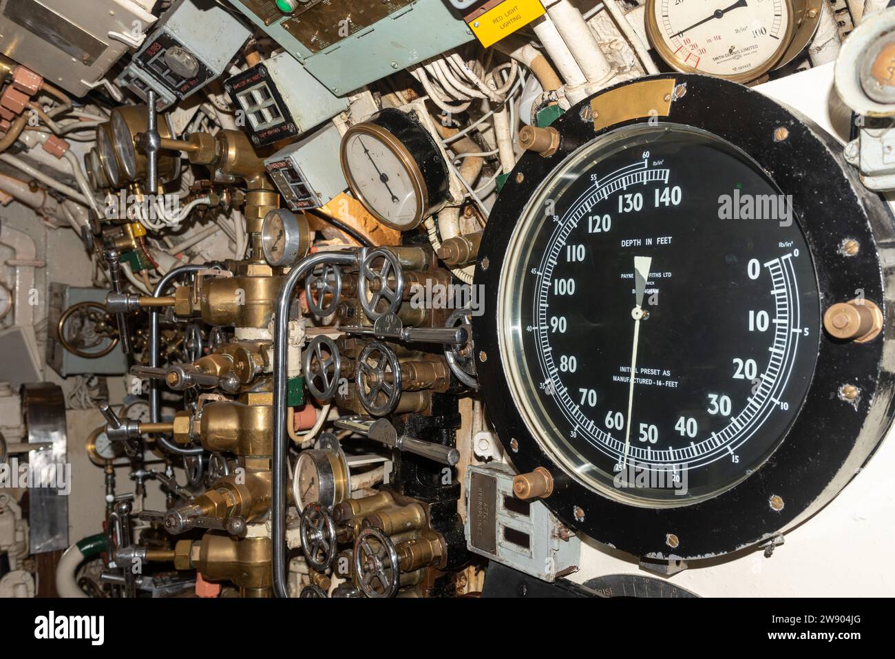 Interior mechanics and workings with various dials inside HMS Alliance, part of the submarine museum in Gosport, England. December 2023. Stock Photo