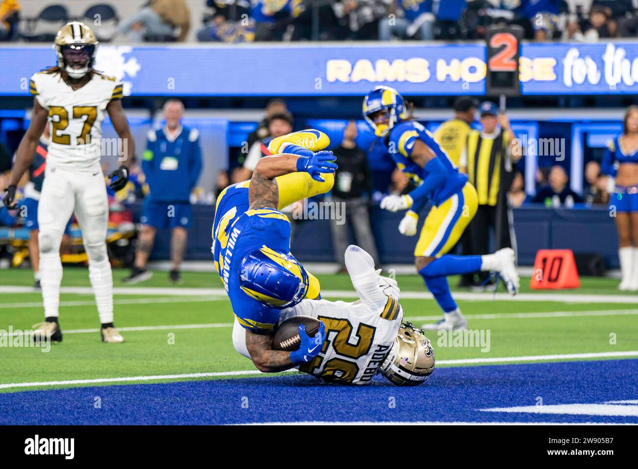 Los Angeles Rams running back Kyren Williams (23) leaps in for a touchdown against New Orleans Saints cornerback Paulson Adebo (29) during a NFL game, Stock Photo