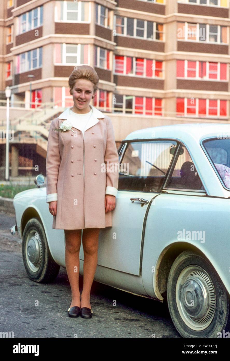 Young lady stood by a car 1970 Stock Photo