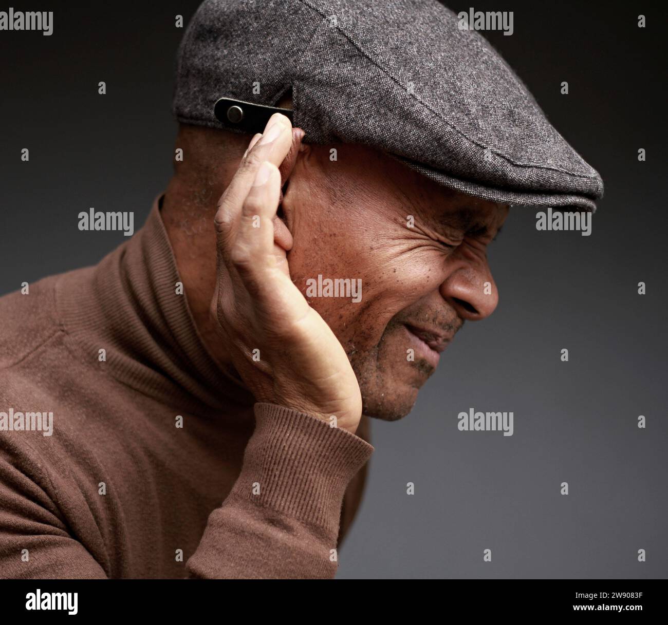deafness suffering from hearing loss on grey black background with people stock image stock photo Stock Photo