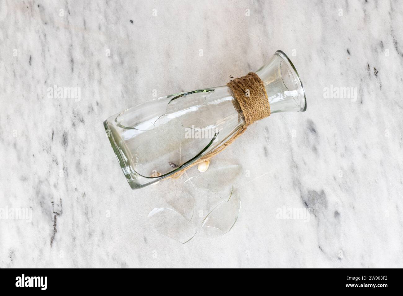 Broken glass vase shattered on a marble floor Stock Photo Alamy
