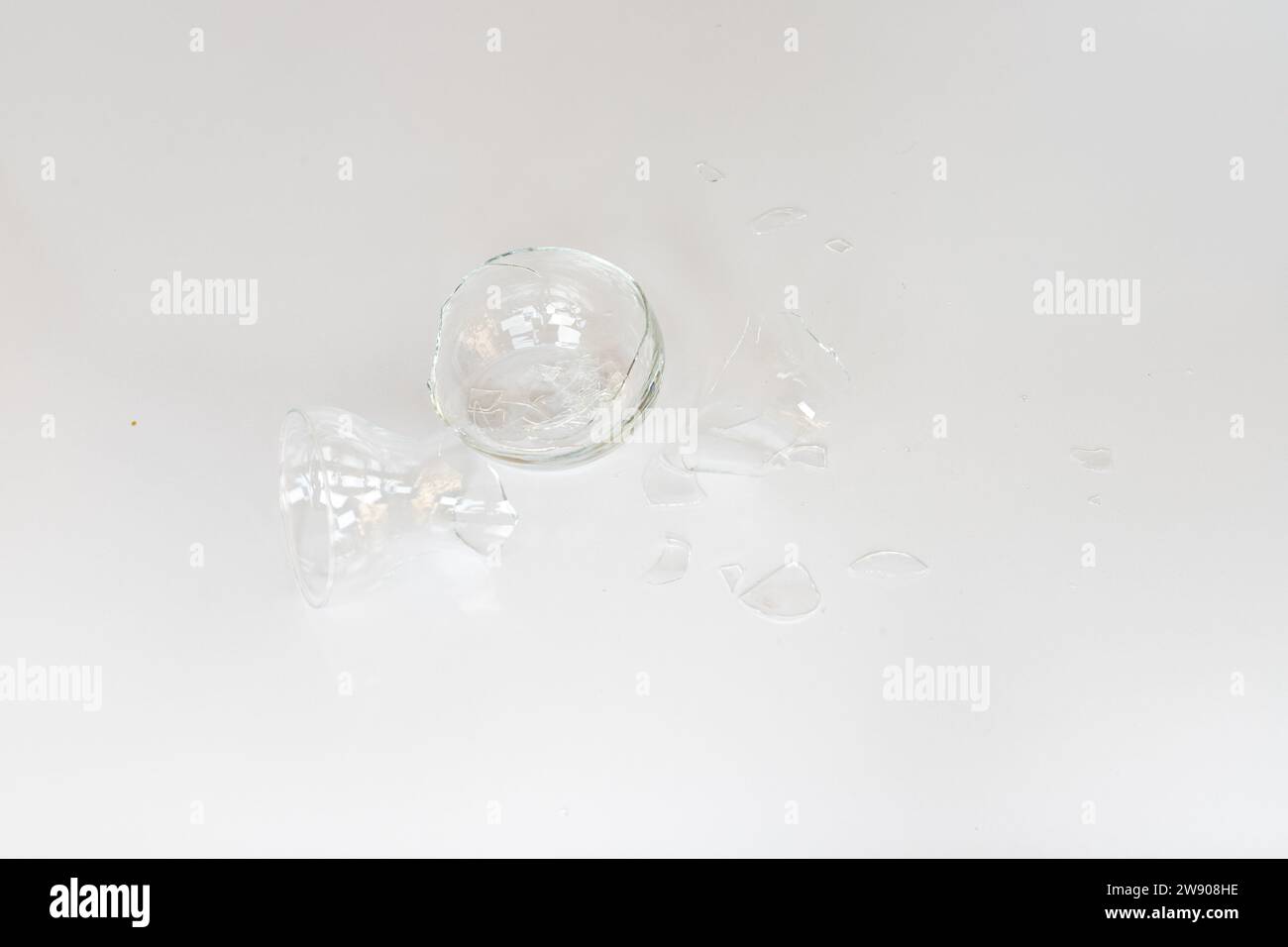 Broken glass vase with sharp edges isolated on white background Stock