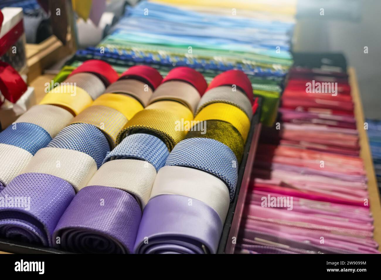 Ties of red shade and twisted into spiral colorful tones with strict ...