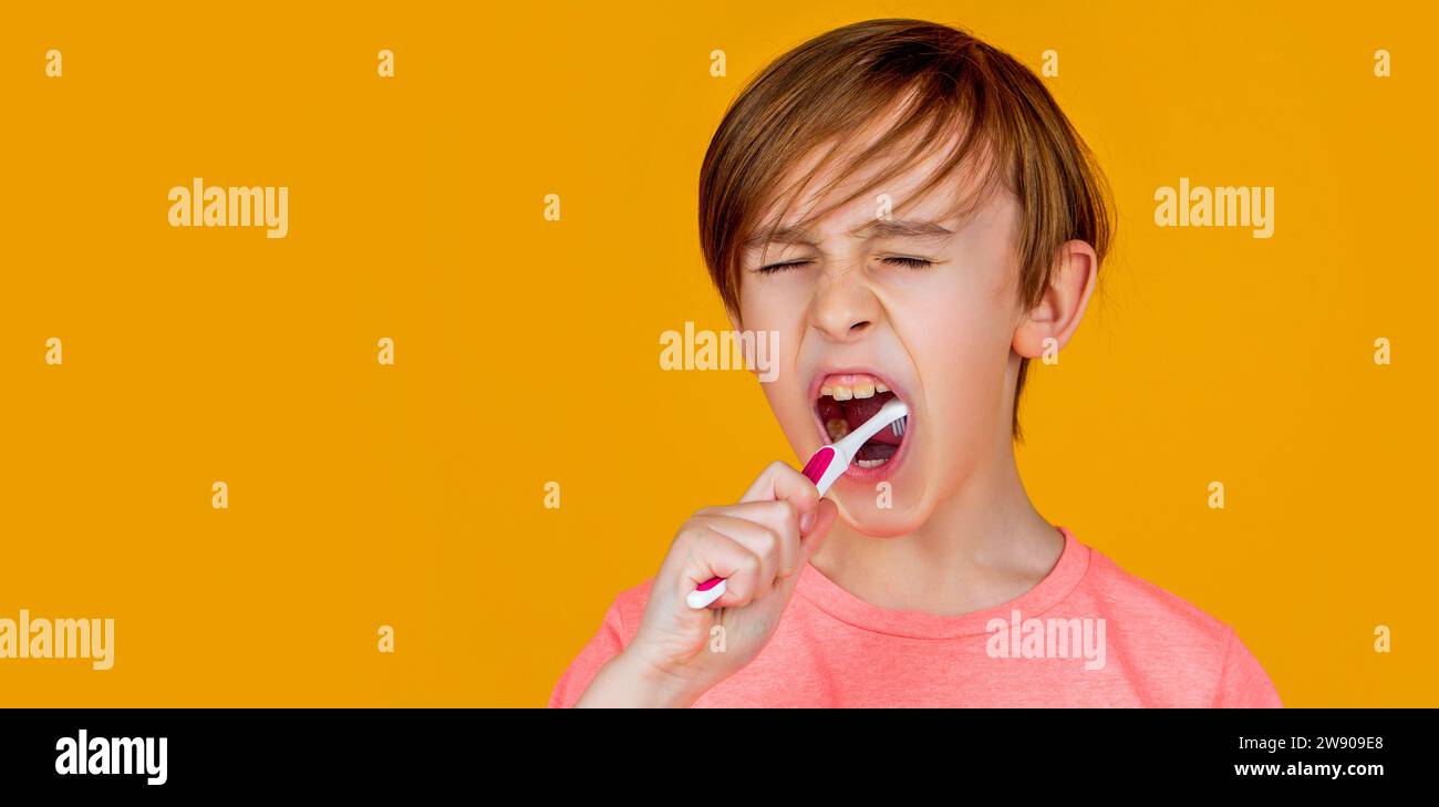 Little boy cleaning teeth with kids toothbrush. Dental hygiene. Little man brushing teeth. Happy child kid boy with toothbrush. Health care, dental Stock Photo