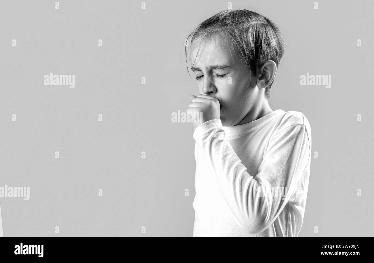 Disease concept. A sick boy child coughs. Child is ill, he coughs. Treatment of colds and flu. Boy coughing sick colds sneezing cough. Child got sick Stock Photo