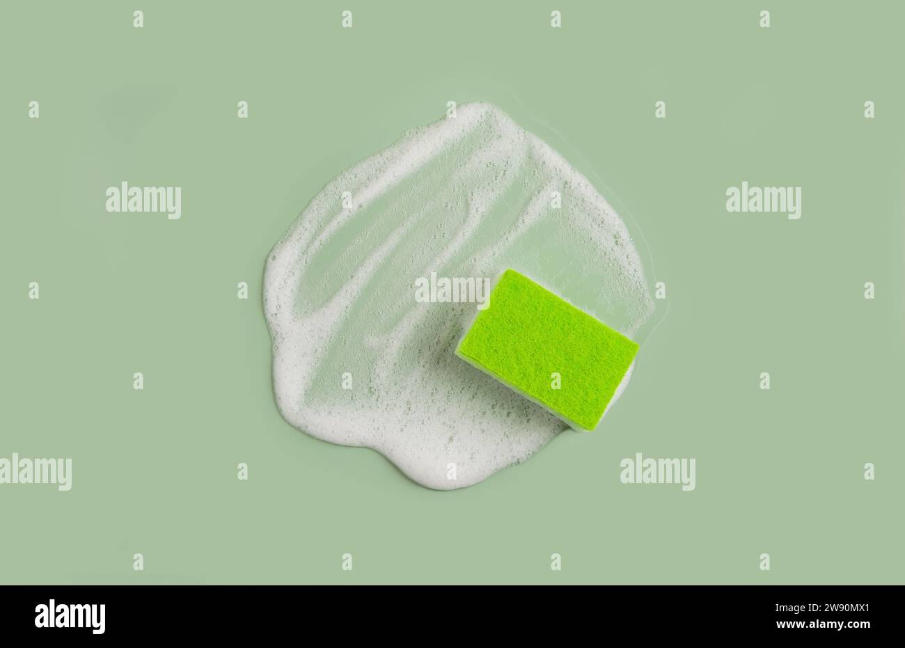 Washing Sponge lying on surface in soapy foam Stock Photo