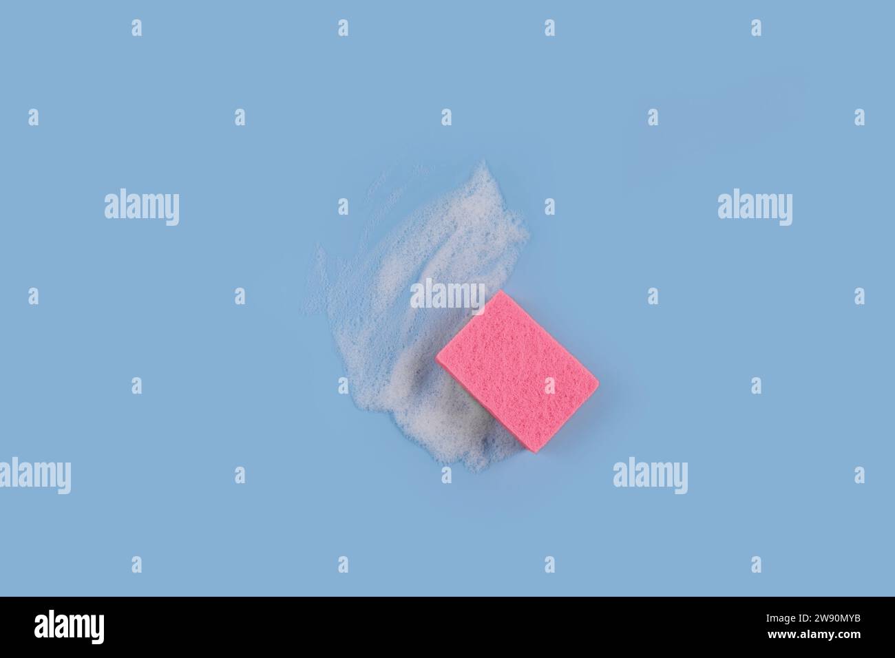 Washing Sponge lying on surface in soapy foam Stock Photo