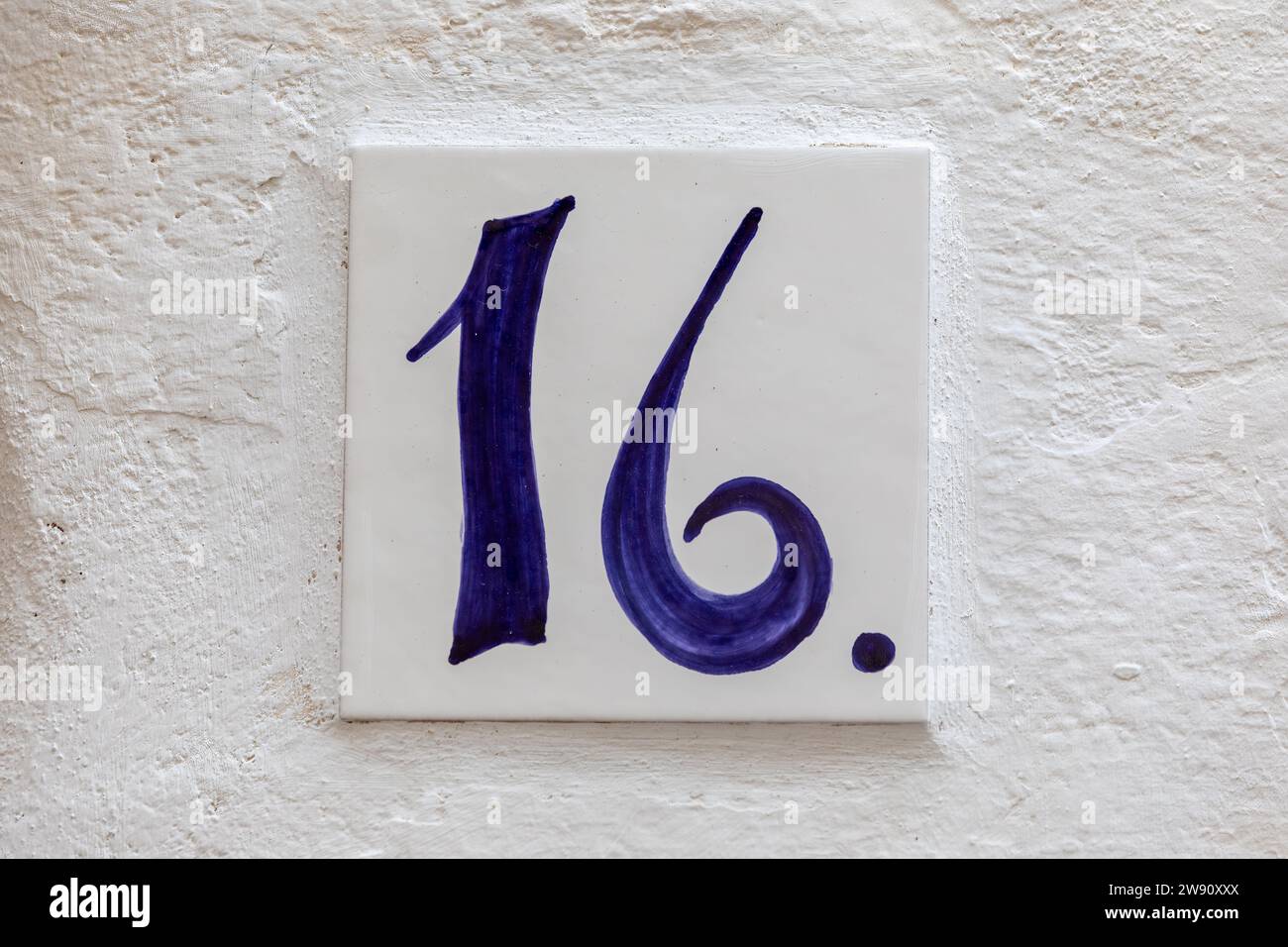 Old Weathered House Number 16, Tile on Wall Stock Photo