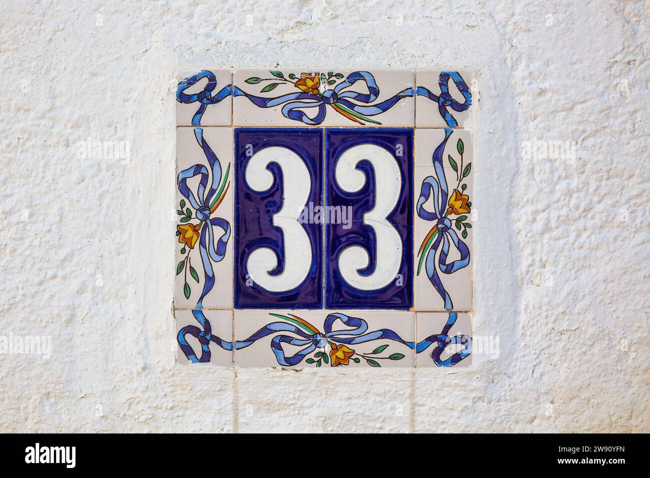 Number 33 House Tile on Wall Stock Photo