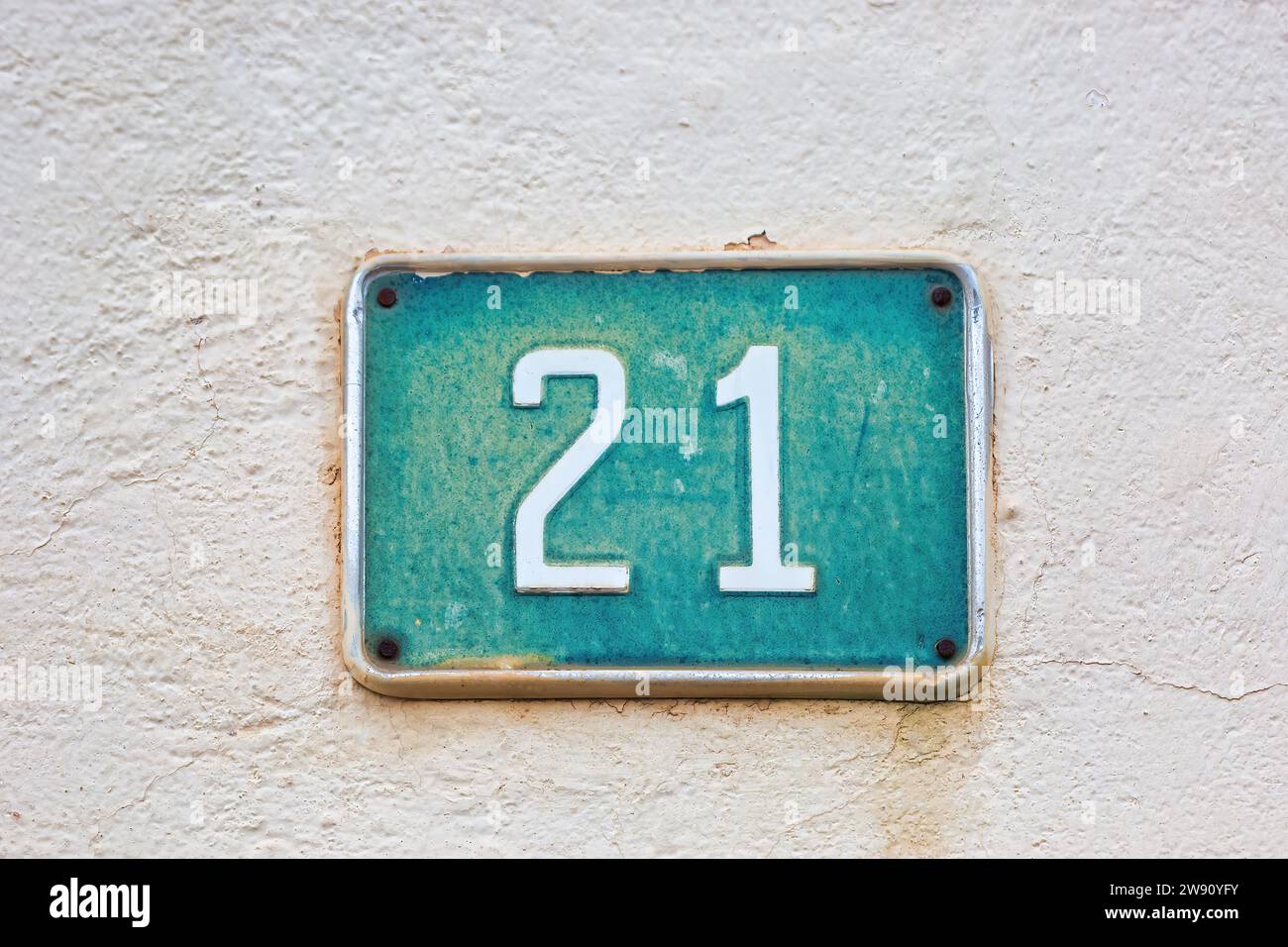 House Number 21 on White Wall: Address Marker for Home Stock Photo
