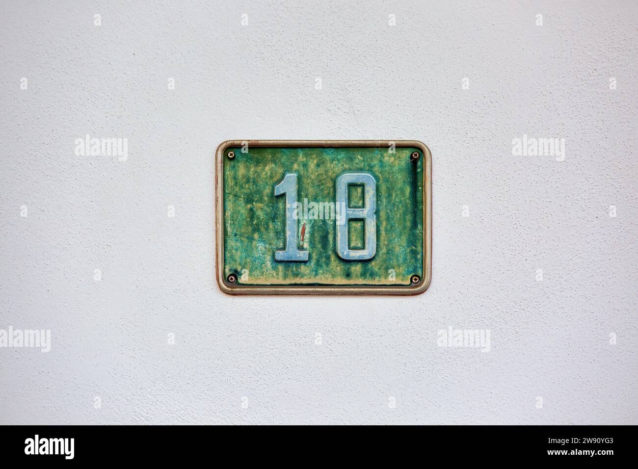 House Number 18: Address Marker on House Wall Stock Photo