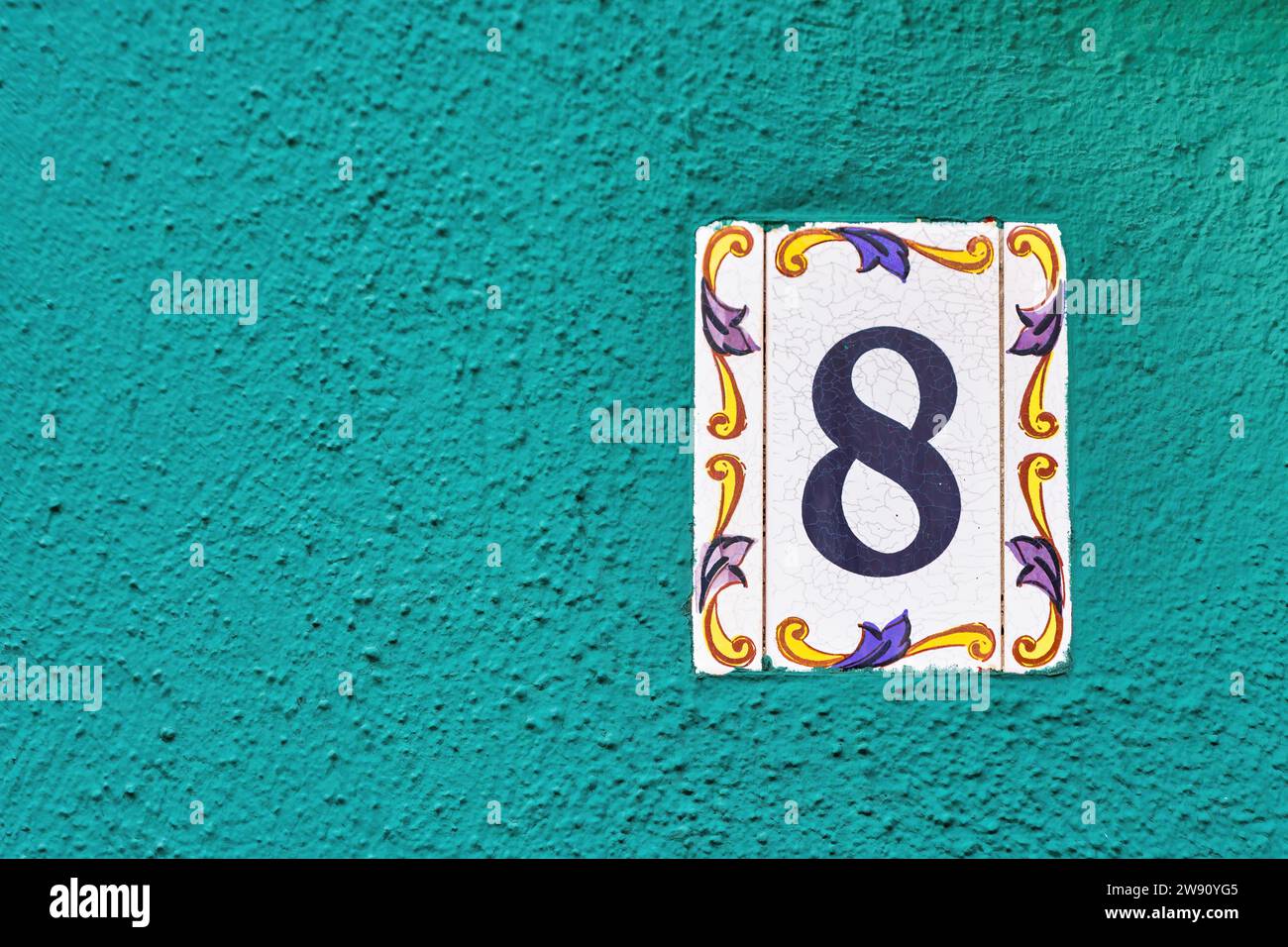 House Number 8: Address Marker on House Wall Stock Photo