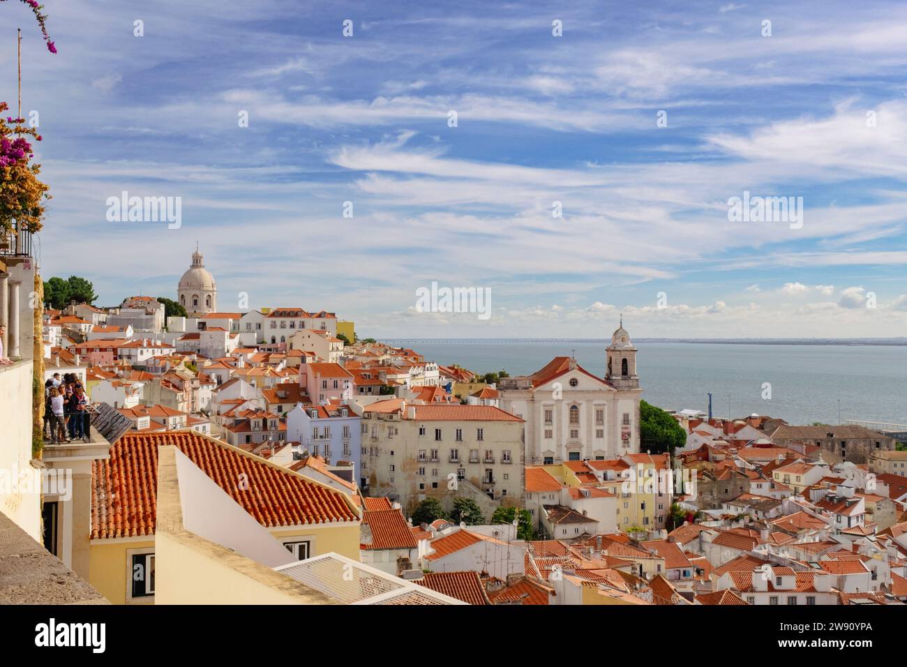 View to the river across red rooftops of old buildings in beautiful district of Alfama, Lisbon, Portugal, Europe. Stock Photo